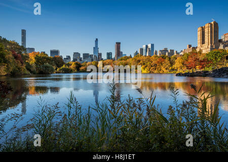 Fall in Central Park at The Lake with Midtown and Upper West Side skyscrapers. Autumn foliage in New York City Stock Photo