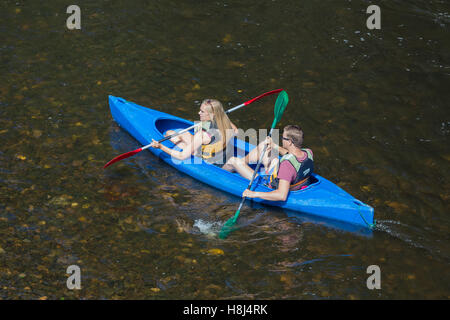 Girl and boy in kayak on at river Ourthe near La Roche-en-Ardenne, Belgium Stock Photo