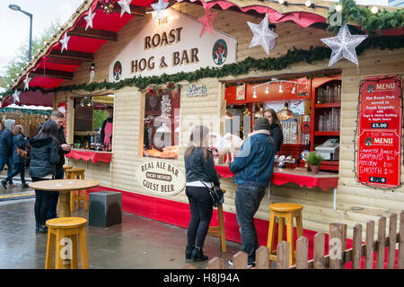 'Roast Hog & Bar' temporary food stall as part of the Christmas markets in Manchester City centre, UK. Stock Photo