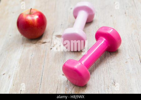 Weights and fruit on wooden background healthy living concept Stock Photo