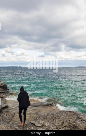 The Grotto, a top tourism attractions in Bruce Peninsula National Park, Ontario. The Grotto was carved out by the waves of Georgian Bay over thousands of years. The natural rock formation and surrounding crystal clear water create a unique and memorable v Stock Photo