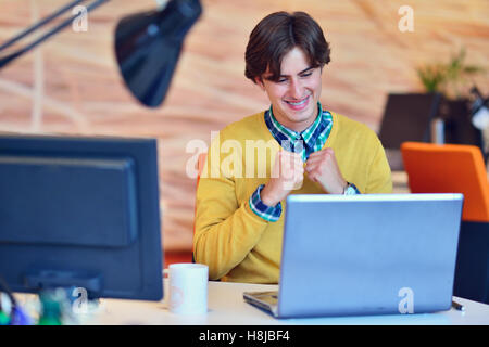 Man working in office in front on notebook Stock Photo
