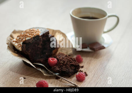 Morning aromatic coffee with a muffin raspberries and chocolate for Breakfast. Stock Photo