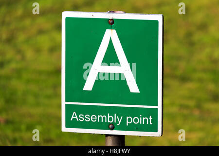 Green and white Assembly point sign Stock Photo