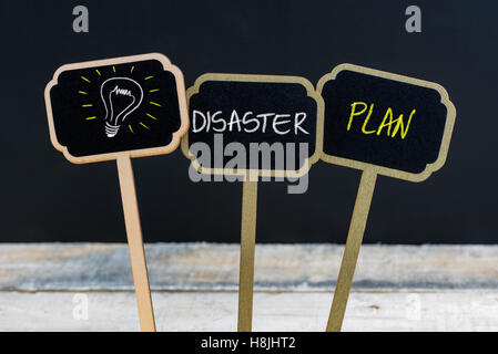 Concept message DISASTER PLAN and light bulb as symbol for idea written with chalk on wooden mini blackboard labels Stock Photo
