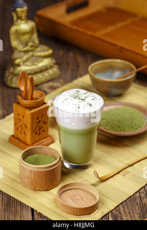 Still life with Japanese matcha accessories and matcha tea latte in glass Stock Photo