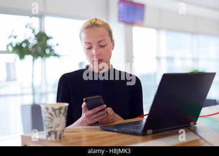 Female freelancer remotely working on the go. Stock Photo
