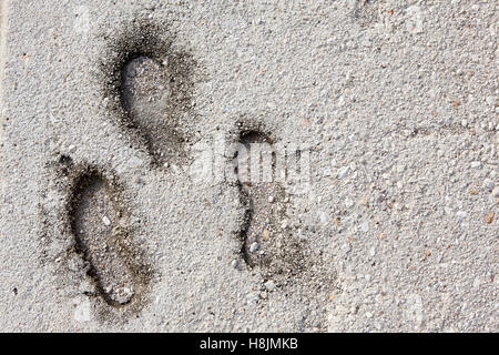 Foot print on grunge concrete texture Stock Photo