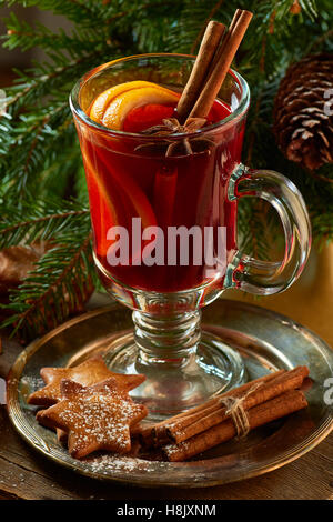 Mulled wine with cinnamon sticks,  ginger cookies and spruce branches Stock Photo