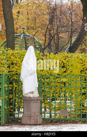 Sculpture by white cloth during a snowfall, Summer Garden, St. Petersburg, Russia Stock Photo