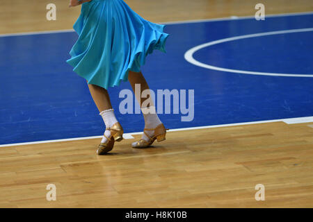 Legs of a dancing girl in the competition on sports dances Stock Photo