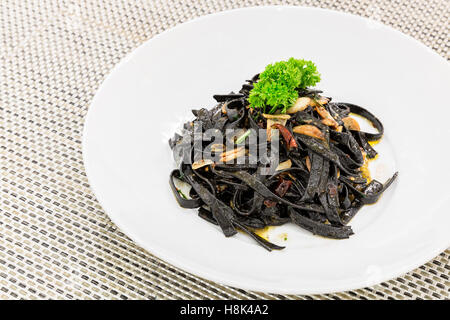 Fresh black aglio olio pasta with garlic and chilli Stock Photo