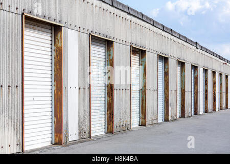Self Storage Unit Shutter door or roller door of factory building use for industrial background. Stock Photo