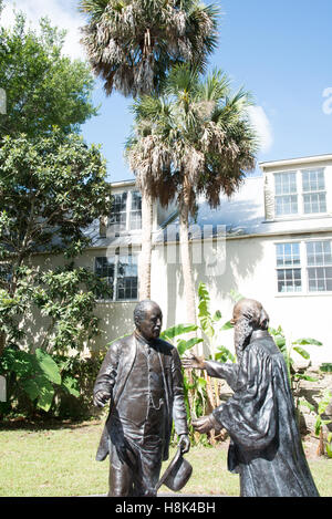 Behind a house along Aviles Street is a peaceful courtyard with these statues titled Sons of St. Augustine. Stock Photo