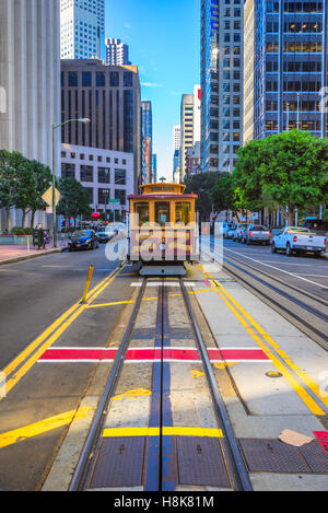 SAN FRANCISCO, USA - DECEMBER 16: Passengers enjoy a ride in a cable car on Dec 16, 2013 in San Francisco. It is the oldest mech Stock Photo