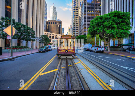 SAN FRANCISCO, USA - DECEMBER 16: Passengers enjoy a ride in a cable car on Dec 16, 2013 in San Francisco. It is the oldest mech Stock Photo