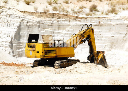 Old yellow dredge in sandy to career Stock Photo