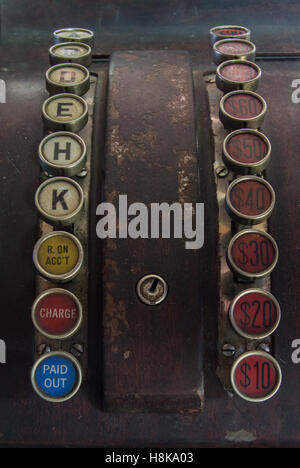 Close up of antique wooden cash register with two columns of keys with letters, dollar amounts, paid out, charge, and r on acc't Stock Photo