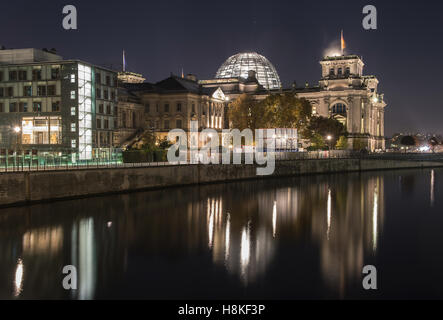 Berlin, Germany. 12th Nov, 2016. The lights of the German Reichstag building and the Bundestag next to it shine bright and throw shimmering reflections upon the river spree. Photo: Paul Zinken/dpa/Alamy Live News Stock Photo