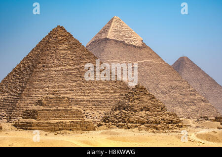 Cairo, Egypt The three Great pyramids of Giza against a clear blue sky. From left to right stands the Pyramid of Mekaure (smalle Stock Photo