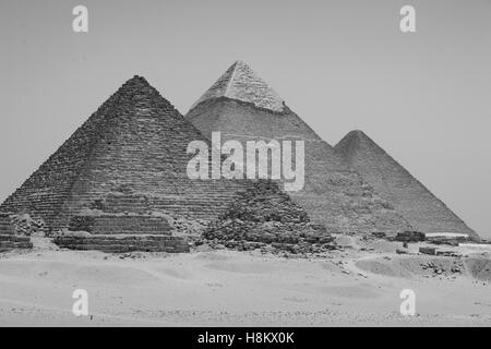 Cairo, Egypt Vast Sahara desert with the three Great pyramids of Giza against a cloudless sky. From left to right stands the Pyr Stock Photo