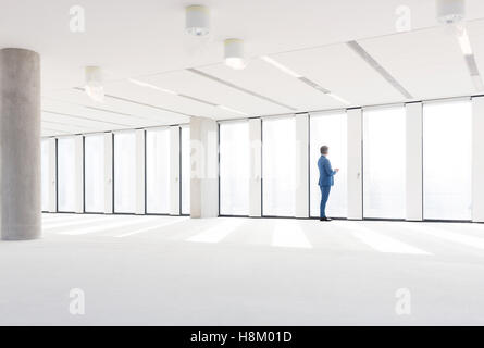 Mature businessman visiting empty office space Stock Photo