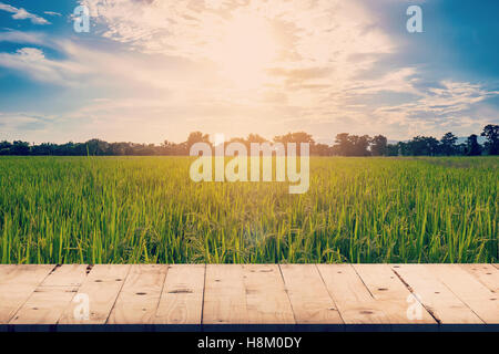 Rice field and wood table background with space display for product Stock Photo