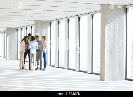 Full length of business people having discussion in empty office Stock Photo