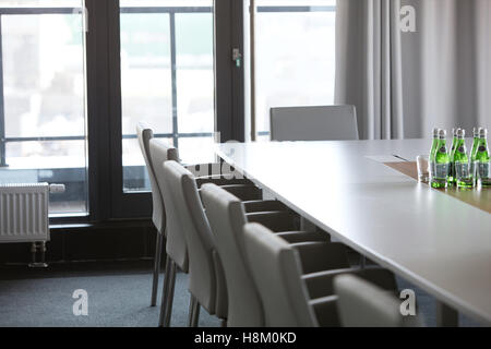 Chairs at conference table in modern office Stock Photo