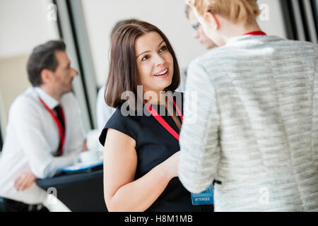 Businesswomen talking during coffee break at convention center Stock Photo