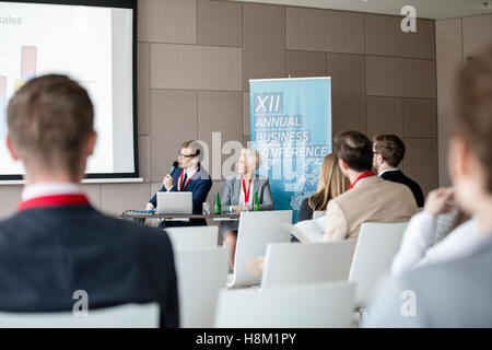 Businessman giving presentation in seminar hall Stock Photo