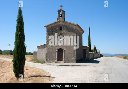 Small rural Catholic Church in South East France with few windows and sporting only a simple bell tower and a small star window. Stock Photo