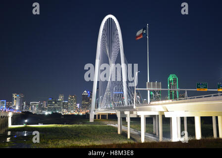 The Margaret Hunt Hill bridge is illuminated at night and provides dramatic views of the Dallas skyline. Stock Photo