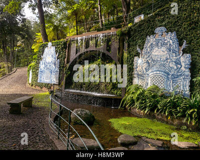 Blue painted tiles and a waterfall in the Monte Palace Tropical Garden in Funchal, Madeira, Portugal Stock Photo