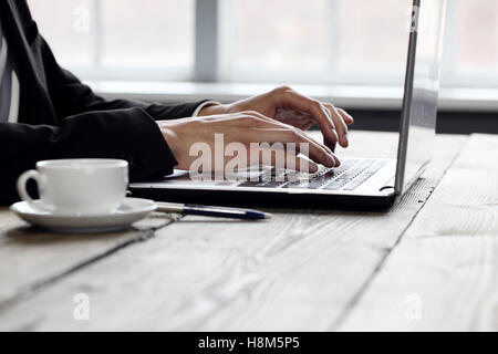 Business man working on laptop, close up of hands and coffee Stock Photo