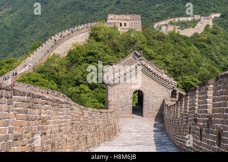 Mutianyu, China - Landscape view of tourists walking on the Great Wall of China. The wall stretches over 6,000 mountainous kilom Stock Photo