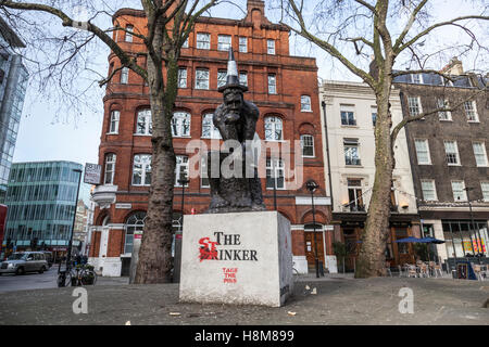 'The Drinker' a sculpture by Banksy, now amended by the artist AK47 and renamed 'The Stinker' in Shaftesbury Avenue. London. Stock Photo