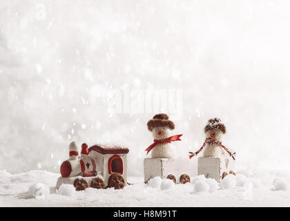 Toy train set carrying snowmen in winter setting Stock Photo