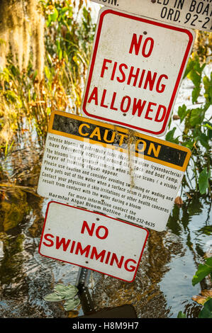Warning signs near a boat ramp on Lake Harris in Leesburg, Florida, USA. Stock Photo