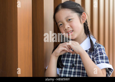 Smiling child, girl, in school uniform portrait. Stock Photo