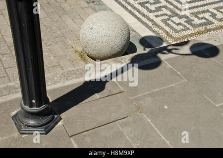 Vintage street lamp shadow on sidewalk, Rhodes island, Greece Stock Photo