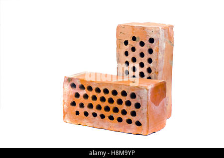 Two old red clay brick with holes isolated on white background Stock Photo