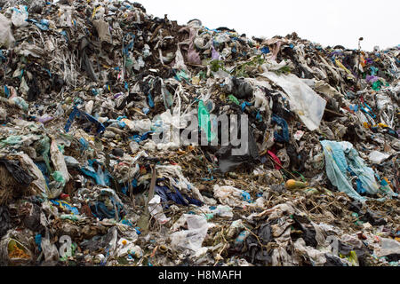 Pile of plastic bags and other refined petroleum products dumped in landfill. Garbage heap gives infiltrate into ground. Waste sorting is required. Lviv city Stock Photo