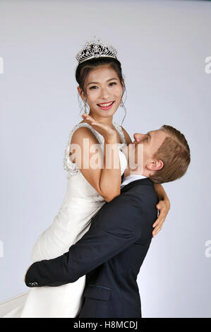 Mixed Race Bride and Groom in Studio Stock Photo