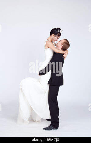 Mixed Race Bride and Groom in Studio Stock Photo