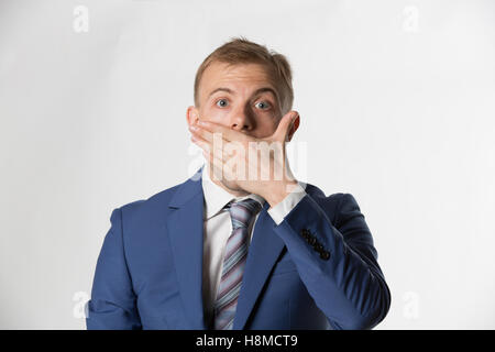 Shocked Businessman covering his mouth Stock Photo