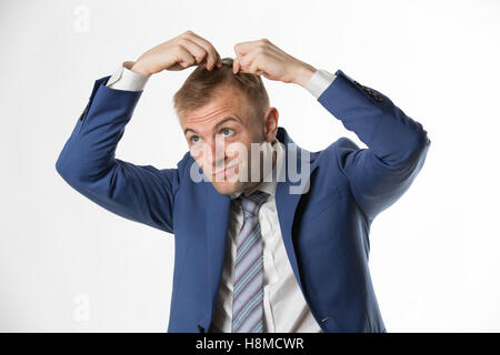 Businessman checking his hair indicating hair loss Stock Photo