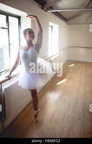 Ballerina practising ballet dance at barre Stock Photo