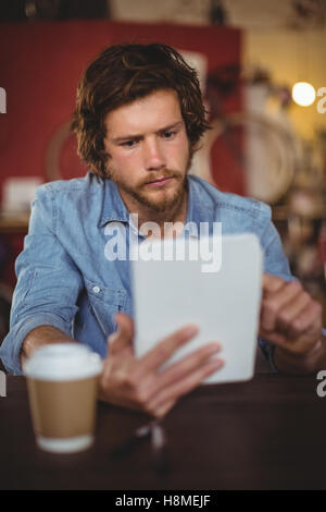 Handsome mechanic using digital tablet Stock Photo
