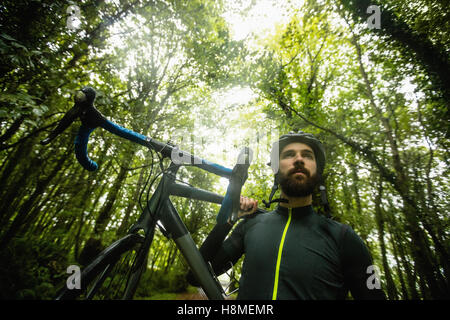 Athlete carrying a bicycle Stock Photo